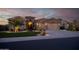 Charming single-story home with a three-car garage, well-manicured lawn, and stone accents at 15664 W Vernon Ave, Goodyear, AZ 85395