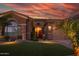 Inviting home with a beautiful front lawn, mature landscaping, and stone accents at 15664 W Vernon Ave, Goodyear, AZ 85395