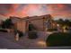Attractive home exterior with desert landscaping, stone accents, and a tile roof at 15664 W Vernon Ave, Goodyear, AZ 85395