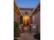 Charming gated front entrance with stone pillars and a well-manicured bush at 15664 W Vernon Ave, Goodyear, AZ 85395