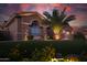 Beautifully landscaped front yard with a palm tree and decorative stone at 15664 W Vernon Ave, Goodyear, AZ 85395