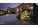 Lush landscaping featuring desert plants and rocks with a three-car garage at 15664 W Vernon Ave, Goodyear, AZ 85395