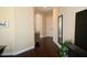 Hallway features dark wood floors and neutral-toned walls with decorative mirror at 15664 W Vernon Ave, Goodyear, AZ 85395