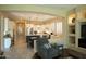 Open kitchen with modern appliances, white cabinetry, a center island, and a cozy dining area at 15664 W Vernon Ave, Goodyear, AZ 85395