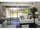 Cozy living room with a sliding glass door providing access to the backyard and lots of natural light at 15664 W Vernon Ave, Goodyear, AZ 85395