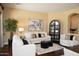 Comfortable living room with white sofas, stylish decor, and view into the dining area at 15664 W Vernon Ave, Goodyear, AZ 85395