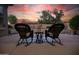 Cozy outdoor patio setup with comfortable rocking chairs and a small table, perfect for enjoying serene views at 15664 W Vernon Ave, Goodyear, AZ 85395