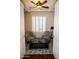 Bright sitting room features wood floors, neutral walls, stylish furniture, and a window with plantation shutters at 15664 W Vernon Ave, Goodyear, AZ 85395