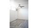 This is a bedroom that has grey wood-look flooring, a fan, and air conditioning at 2035 W Claremont St, Phoenix, AZ 85015