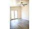 Bedroom with light gray flooring, ceiling fan, and access to the backyard through glass doors at 2035 W Claremont St, Phoenix, AZ 85015