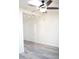 This bedroom has gray wood-look flooring and a modern ceiling fan at 2035 W Claremont St, Phoenix, AZ 85015