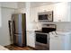 Modern kitchen with stainless steel appliances, quartz countertops, and plenty of cabinet storage at 2035 W Claremont St, Phoenix, AZ 85015
