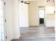 Spacious living room with light gray floors leading to the kitchen and a bathroom at 2035 W Claremont St, Phoenix, AZ 85015
