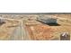 New construction home showing the exterior with dirt landscaping and a water tank at 23134 W Duane Ln, Wittmann, AZ 85361