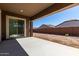 Covered patio with a concrete floor, perfect for relaxing and overlooks an empty backyard at 24054 N 171St Dr, Surprise, AZ 85387