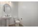 A clean, neutral bathroom with a pedestal sink and modern fixtures at 24054 N 171St Dr, Surprise, AZ 85387
