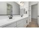 Modern bathroom features double sinks, sleek fixtures, and a well-lit mirror at 24054 N 171St Dr, Surprise, AZ 85387