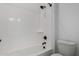 Clean and modern tub and shower combination with sleek, updated fixtures and a toilet at 24054 N 171St Dr, Surprise, AZ 85387