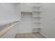 Walk-in closet offering shelving and rods for ample storage at 24054 N 171St Dr, Surprise, AZ 85387