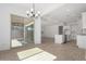 Open floor plan with tile flooring leading to sliding doors and a bright dining area at 24054 N 171St Dr, Surprise, AZ 85387
