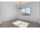 This dining room has tile flooring, a contemporary chandelier and a view to the outside at 24054 N 171St Dr, Surprise, AZ 85387
