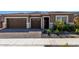 Charming single-story home with brown exterior, landscaped yard, and two-car garage at 24054 N 171St Dr, Surprise, AZ 85387