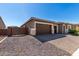 Beautiful home with a three-car garage, elegant stone accents, and a charming front yard at 24054 N 171St Dr, Surprise, AZ 85387