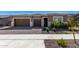 Charming home featuring a three-car garage, stone accents, and a well-maintained front yard at 24054 N 171St Dr, Surprise, AZ 85387