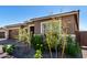 Lovely home with a three-car garage, stone detailing, and a landscaped front yard at 24054 N 171St Dr, Surprise, AZ 85387