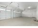 Spacious three-car garage with white doors and ample room for parking and storage at 24054 N 171St Dr, Surprise, AZ 85387