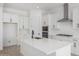 Bright, open kitchen features white cabinets, stainless steel appliances, and a large island at 24054 N 171St Dr, Surprise, AZ 85387