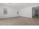Spacious, empty living room with tile flooring, recessed lighting, and neutral walls at 24054 N 171St Dr, Surprise, AZ 85387