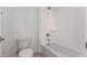 Clean, minimalist bathroom with white tile, a shower-tub combo, and a modern toilet at 24078 N 171St Dr, Surprise, AZ 85387