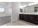 Bathroom featuring a dual sink vanity and a view of the bedroom at 24078 N 171St Dr, Surprise, AZ 85387