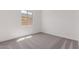 Well-lit bedroom featuring a window, carpet flooring, and neutral wall colors at 24078 N 171St Dr, Surprise, AZ 85387