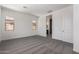 A spacious bedroom with neutral carpeting, white walls, and two windows at 24078 N 171St Dr, Surprise, AZ 85387