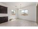 Bright dining area featuring neutral tile flooring, large windows, and a stylish chandelier for elegant dining at 24078 N 171St Dr, Surprise, AZ 85387