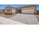 Charming single-story home featuring a three-car garage and stylish paver driveway, perfect for modern living at 24078 N 171St Dr, Surprise, AZ 85387