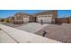 Charming single-story home featuring a three-car garage and stylish paver driveway, perfect for modern living at 24078 N 171St Dr, Surprise, AZ 85387