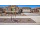 Charming single-story home with manicured front yard, stone accents and three-car garage at 24078 N 171St Dr, Surprise, AZ 85387