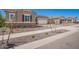 Attractive home showcasing manicured landscaping, a well-kept lawn, and three-car garage at 24078 N 171St Dr, Surprise, AZ 85387