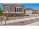Inviting single-Gathering residence, features a stone accent facade, and a three-car garage at 24078 N 171St Dr, Surprise, AZ 85387