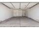 Spacious garage with concrete flooring and ample room for parking and storage at 24078 N 171St Dr, Surprise, AZ 85387