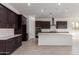 Spacious kitchen with dark cabinetry, white countertops, stainless steel appliances and a large center island at 24078 N 171St Dr, Surprise, AZ 85387