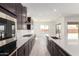 Modern kitchen featuring dark cabinetry, a large island, and stainless steel appliances, perfect for cooking at 24078 N 171St Dr, Surprise, AZ 85387