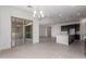 Bright, open-concept living space with tile flooring, seamlessly connected to a modern kitchen with island seating at 24078 N 171St Dr, Surprise, AZ 85387