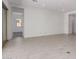 Bright, open-concept living space with neutral tile flooring and large windows, bathed in natural light at 24078 N 171St Dr, Surprise, AZ 85387