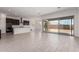 Bright, open-concept living space with tile flooring, seamlessly connected to a modern kitchen with island seating at 24078 N 171St Dr, Surprise, AZ 85387