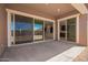 Covered patio with sliding glass doors to provide an ideal indoor/outdoor living space at 24078 N 171St Dr, Surprise, AZ 85387