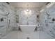 Spacious bathroom featuring a soaking tub, dual shower heads, and elegant white and gold tile at 3010 E Glenrosa Ave, Phoenix, AZ 85016